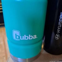 Aqua blue Bubba travel mug with silver base and logo on front