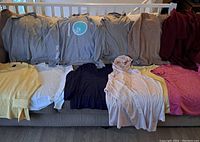 Full view of 11 women's tops in sizes M-XL in various colors and styles.