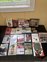 Lot of 23 hockey books arranged on table, showing front covers and spines with various titles and wear.
