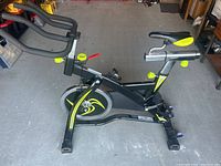 Side view of Pro-Form 320 SPX exercise bike showing frame, seat, flywheel, and base