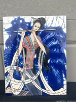 Front view of the ceramic art wall tile featuring a female flutist in a detailed and stylized design with flowing robes and a blue background.