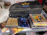 Black leather B&W carrying case on table with several CDs around it including Earth, Wind & Fire's The Eternal Dance and others.