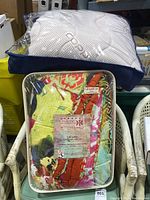 Copper bedding comforter in its original packaging, visible textile and logo on outer navy blue case.