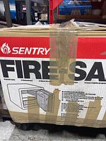 Box front with Sentry branding and fire safe image showing locking bolts and door design