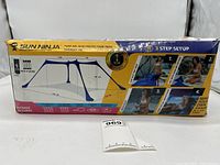 Box front showing Sun Ninja branding, model as UPF 50+ Sun Protection Tent, dimensions, weight, and contents.