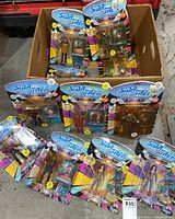 Box containing 12 unopened Star Trek The Next Generation action figures in original packaging with bright colorful background and character images.
