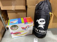 Lot includes boxed Intex unicorn inflatable kiddie pool and Sun Ninja undercover UV protection item in black bag.