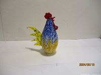Front and side views of a colorful art glass rooster figurine approximately 10 inches high.
