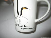 Close-up of the Benjamin Chee Chee two geese design and signature on the mug