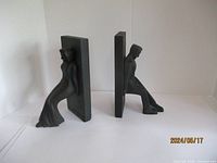 Front and side view of male seated figurine bookend and female standing figurine bookend showing overall shape and size.