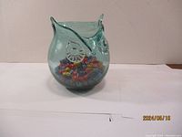 Clear photo of the entire glass owl figurine on a white surface, showing the light greenish-blue transparent glass and owl features.