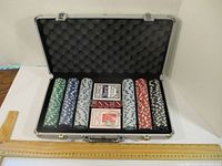 Poker set open to show multi-colored poker chips and two decks of Bicycle playing cards inside a foam-lined aluminum case.