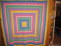 Full view of quilt showing entire geometric pattern and colors.
