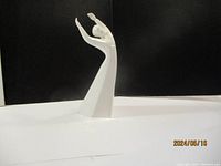 Front view of the Royal Doulton Awakening porcelain figurine showing the figure with arms raised and flowing dress shape.