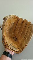 Front view of tan leather Ferland Pro baseball glove showing woven web pocket and Ferland branding.