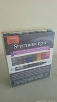 Front view of the Spectrum Noir markers box showing product branding, label, and color preview.