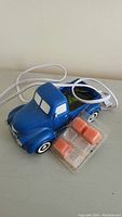Blue truck scent warmer with power cord and orange wax melts