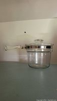 Clear glass Pyrex Flameware double boiler insert with metal band and handle seen from side