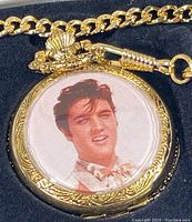 Close-up of the front cover of the gold-tone pocket watch featuring a portrait of Elvis Presley.