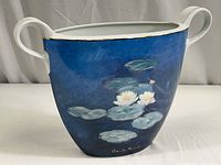 Full view of the porcelain vase showing water lilies artwork and two handles.