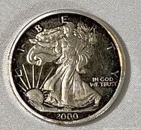 Front side of the 2000 Liberty Silver Millennium Eagle coin showing the Walking Liberty and year 2000.
