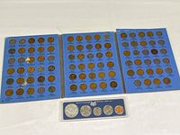 Open Whitman folder with most Lincoln Head cents from 1909 to 1930 visible, showing individual coins and mint marks with associated dates and mintages printed in folder.