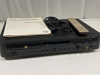 Front view of Marantz DR-17 compact disc recorder with user guide, remote control, and power cord on top.