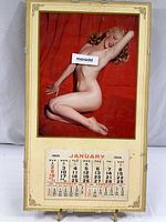Full view of 1955 calendar with Marilyn Monroe nude image mounted in glass frame.