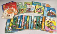 Photo of large assortment of vintage children's books including distinctive colorful covers featuring Disney characters and other classics.