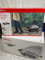 Two stacked Weber boxes showing both the rolling cart box (red top) and the grill box (white bottom) on a countertop