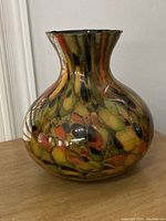 Murano glass vase showing side profile with vibrant multicolor pattern and wide base.