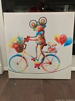 Full front view of the 24x24 colorful frog and dog bicycle canvas print.