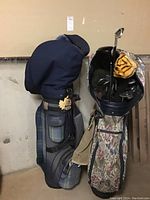 Two golf club sets standing side by side: floral-print bag for women’s left-handed clubs and plaid bag for men’s right-handed clubs.