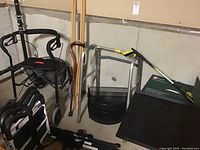 Wide photo showing the Nexxus walker with basket, wooden cane, grabber, bed rails, and boxed toilet seat grouped together.