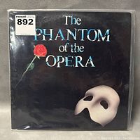 Front cover of The Phantom of the Opera vinyl record, showing title text, red rose, and Phantom mask.