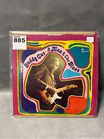 Front cover of Buddy Guy "A Man & the Blues" vinyl record showing colorful design and photo of Buddy Guy playing guitar.