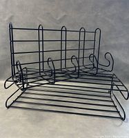 Photo of black metal wire coat rack with hooks visible
