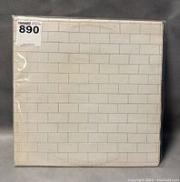 Front view of Pink Floyd The Wall vinyl record gatefold sleeve showing white brick wall pattern with minor wear.
