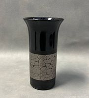 Front view of the vase showing black porcelain with light gray cracked pattern band.