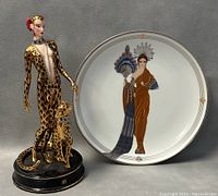 Leopard figurine and Athena collectors plate side by side showing detailed design and proportions.