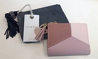 Two new items: Lucky Brand navy pouch with tassel and heart charm, and patchwork multi-tone pink zippered wallet with tassel.