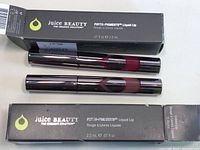 Two new Juice Beauty Phyto-Pigments Liquid Lipsticks in original boxes and tubes, showing color and packaging.