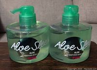 Two green pump bottles of Victoria's Secret Aloe Soothing Body Gel with 'Aloe Sleep' branding and PINK logo.