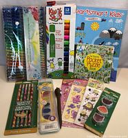 Overview of all items sorted for the lot including paint, crayons, stickers, puzzle book, and activity book.
