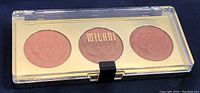 Top view of the Milani blush trio compact with three rose-embossed powder blush shades in soft pink to rose tones.