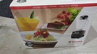Front of original Vitamix TurboBlend VS box showing blender image and food graphics.