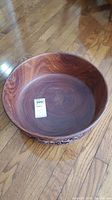 Top view showing smooth interior and wood grain of bowl.