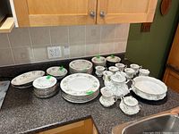 Overview of Paragon First Love dinnerware and tea set on countertop