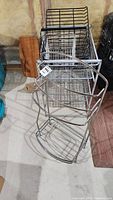 Metal IKEA 4 bin rack with 2 wire baskets and metal shoe rack, black and white metal materials, multiple tiers shown