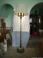 Full view of the silver-plated tri-light floor lamp with marble base, showing the fabric lampshade and metal detailing.